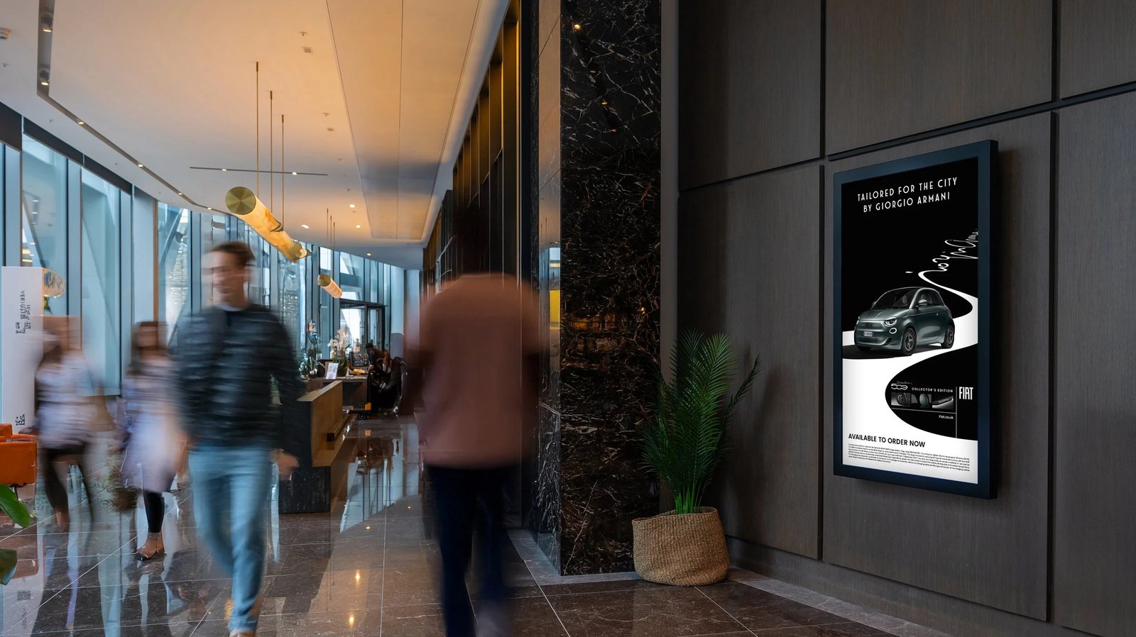 Abode digital screen showing a Fiat 500 campaign in a marble-clad residential lobby